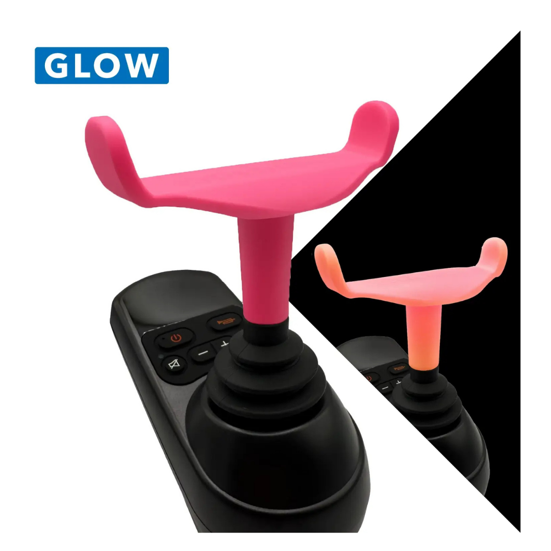 The ComfyGo Ergonomic U-Shaped Joystick Handle with Flex Shaft for powerchairs is shown in pink, fitting over a black joystick with buttons, featuring a close-up and inset image. The word GLOW appears in a blue box.